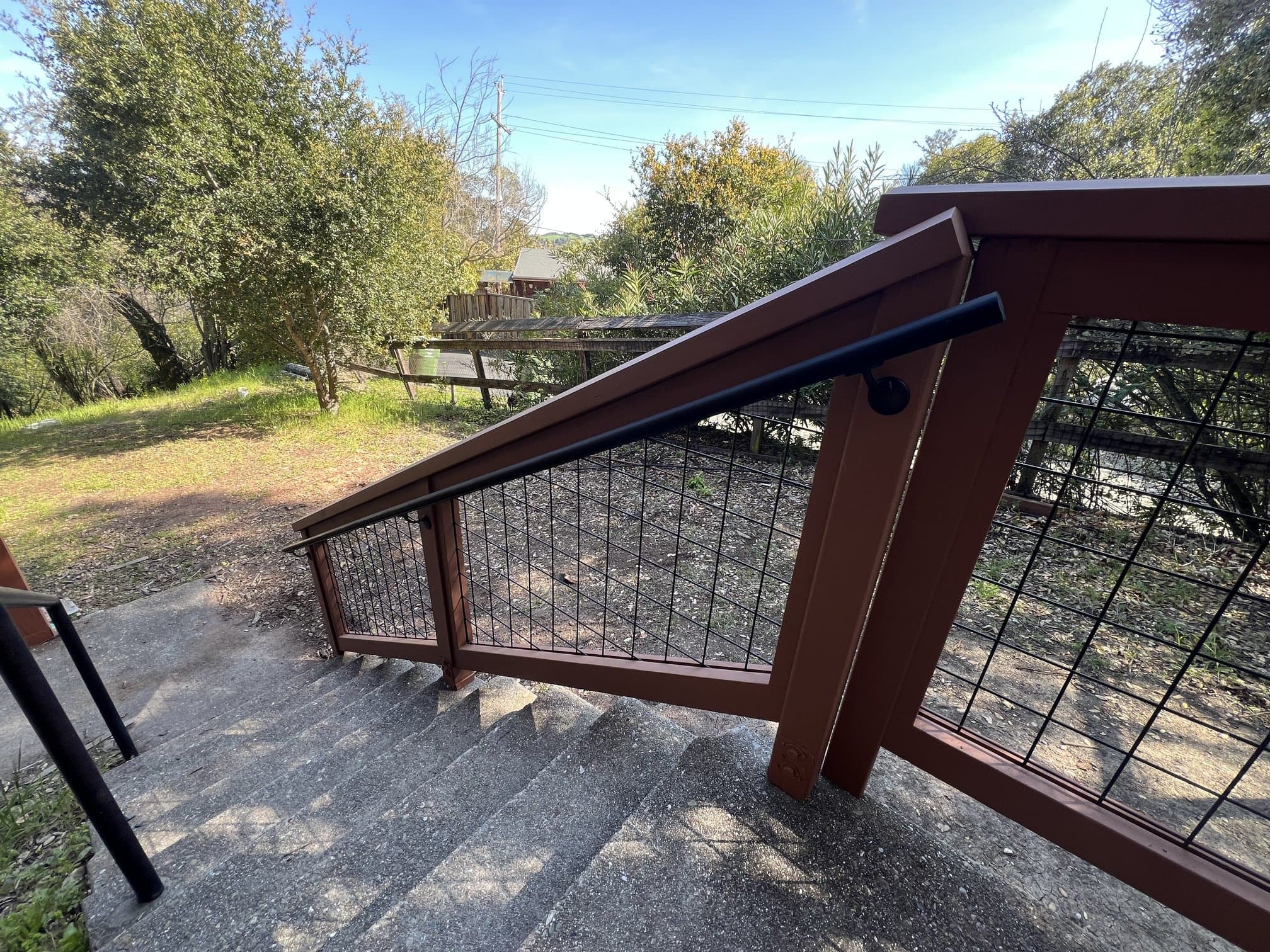 Concrete stairs with redwood and hog-wire railing