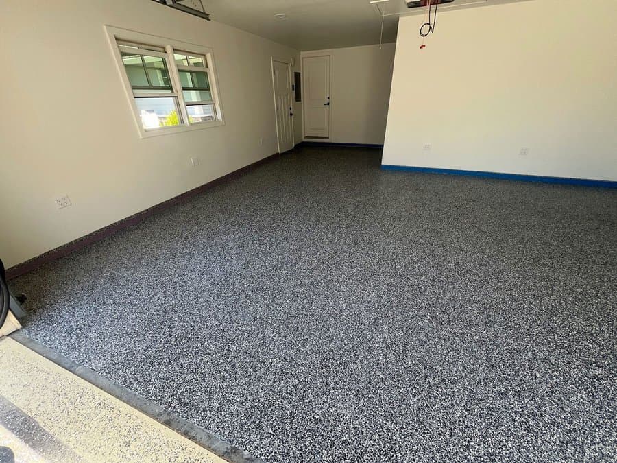 Finished charcoal and white flake epoxy garage floor