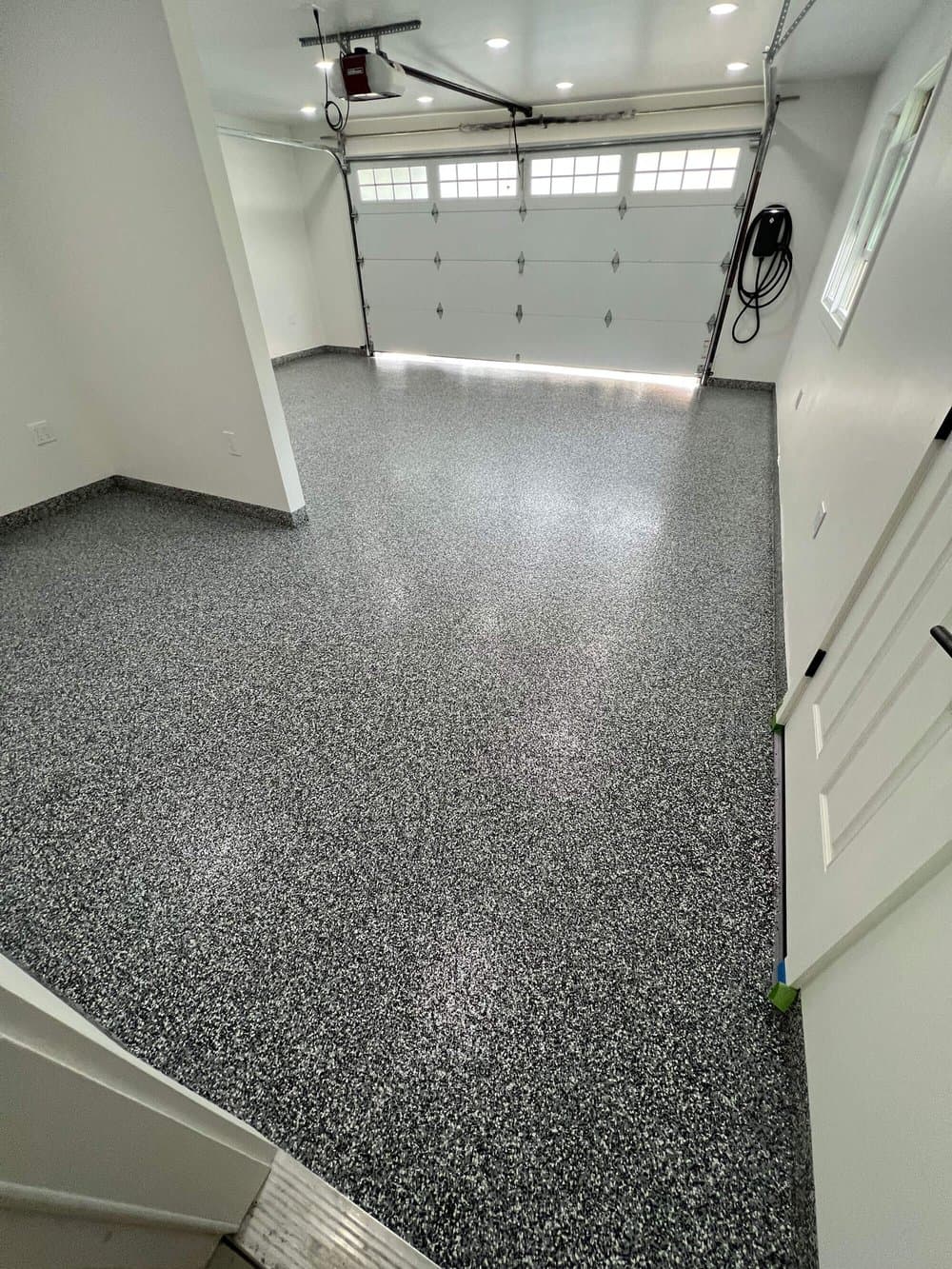 Finished flake epoxy garage floor looking toward the overhead door