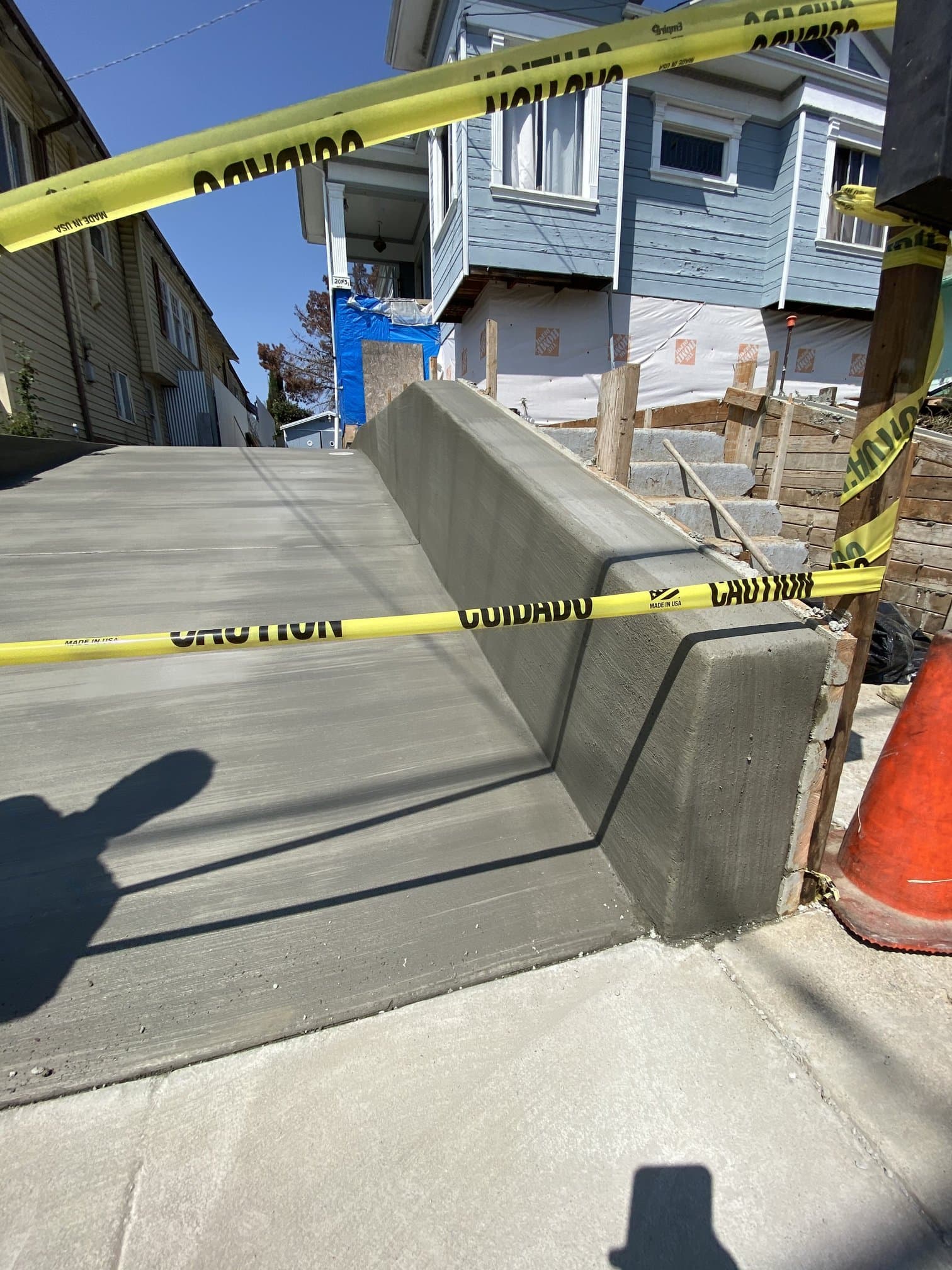New sidewalk and curb concrete finish during cure