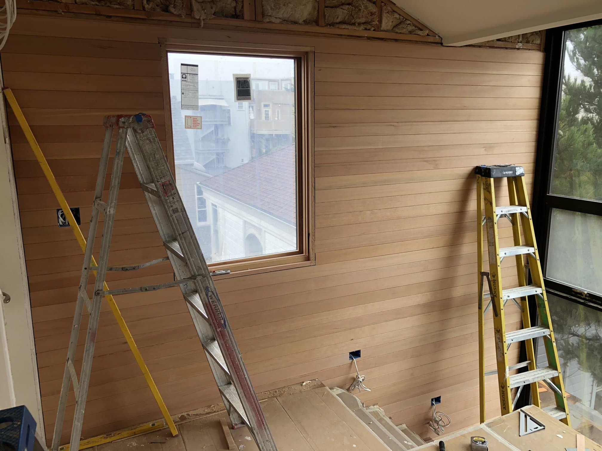 Horizontal wood plank wall paneling during install