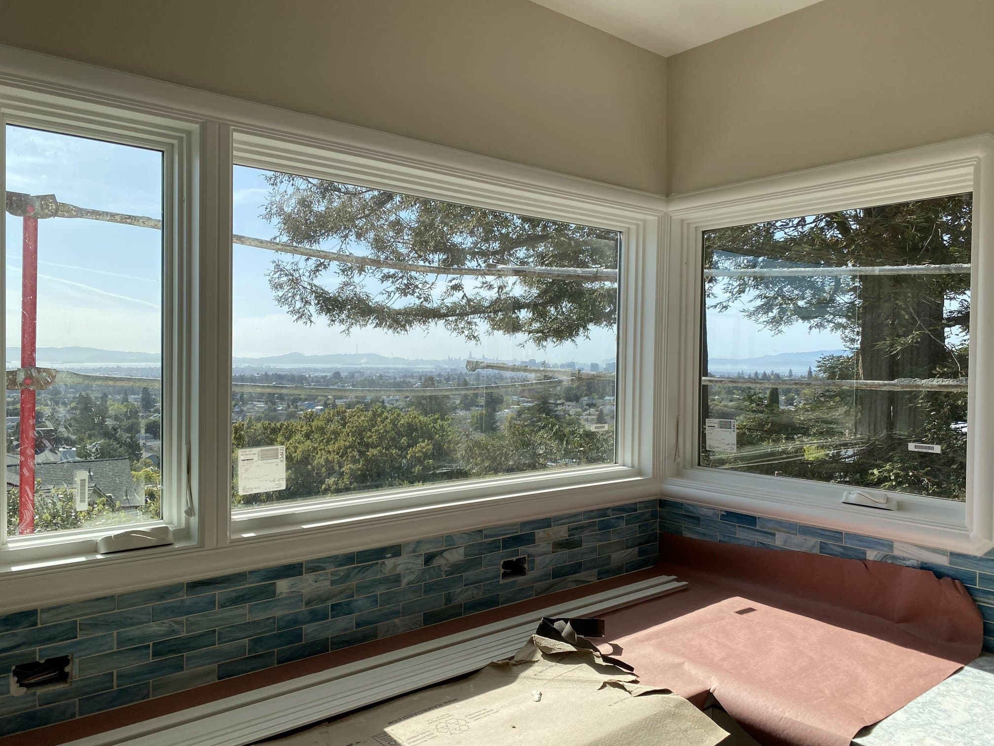Kitchen corner window with blue glass tile backsplash