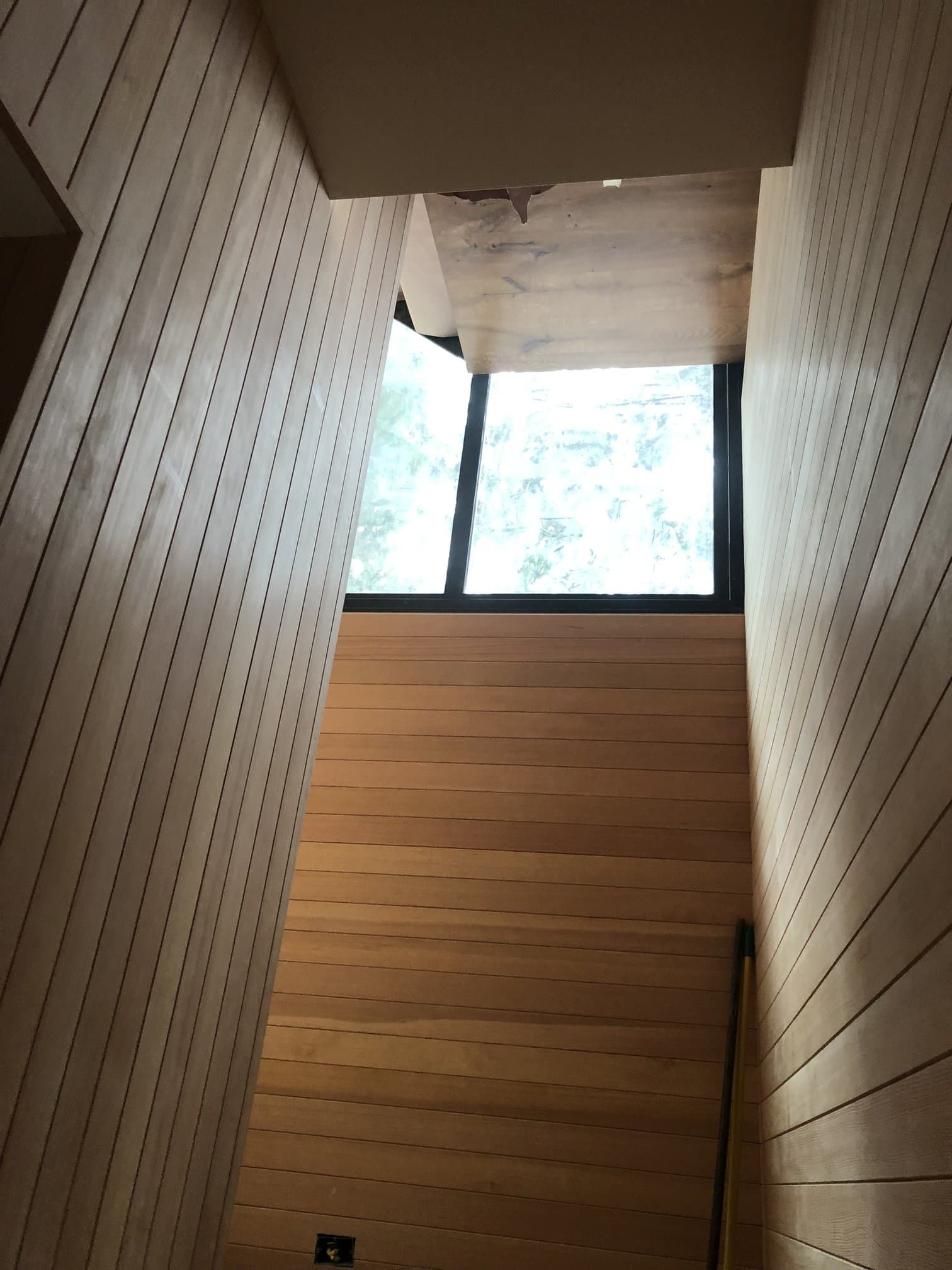 Loft finished in wood plank floor, ceiling, and walls