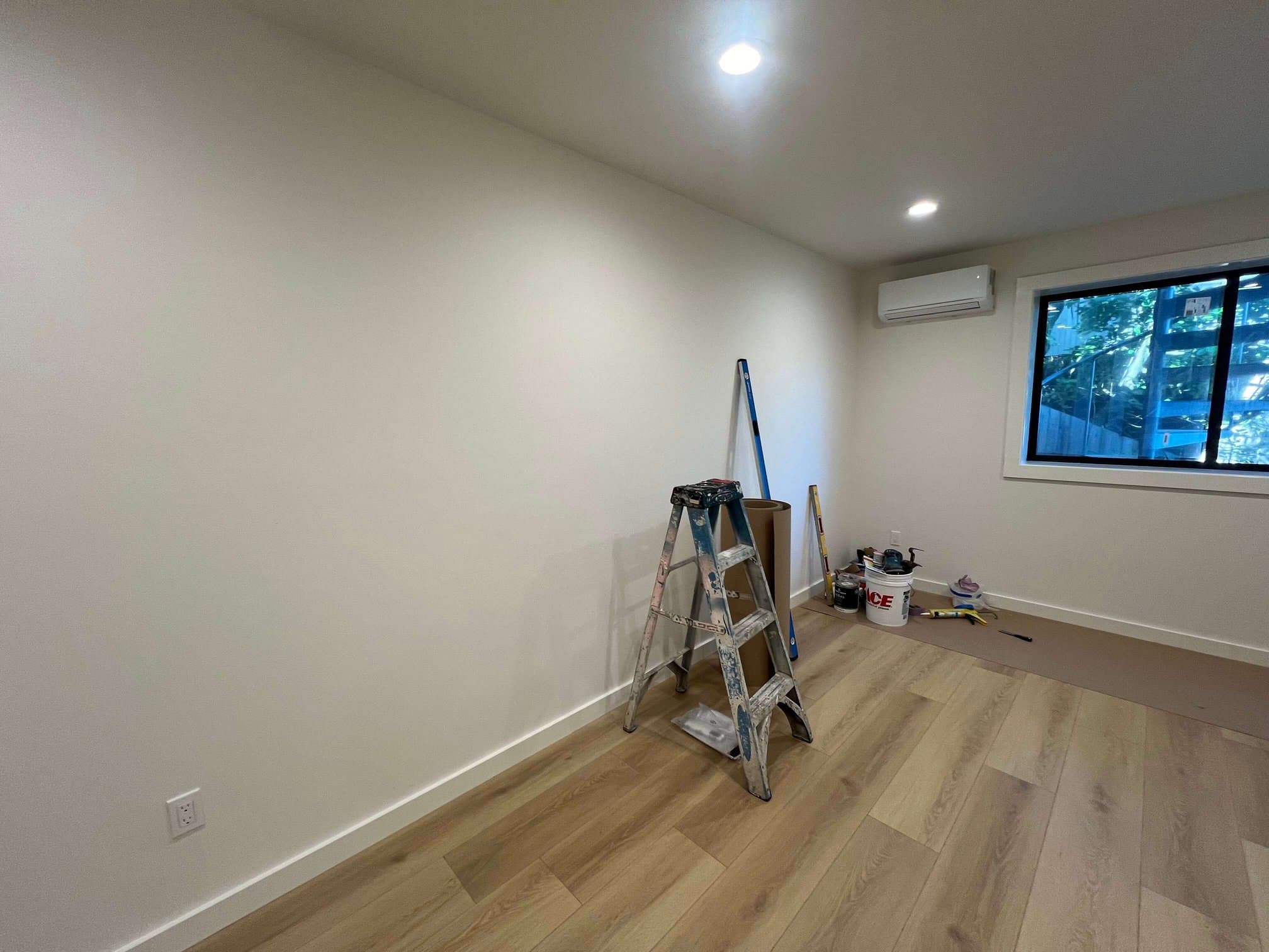 New light oak laminate flooring in a freshly painted room.