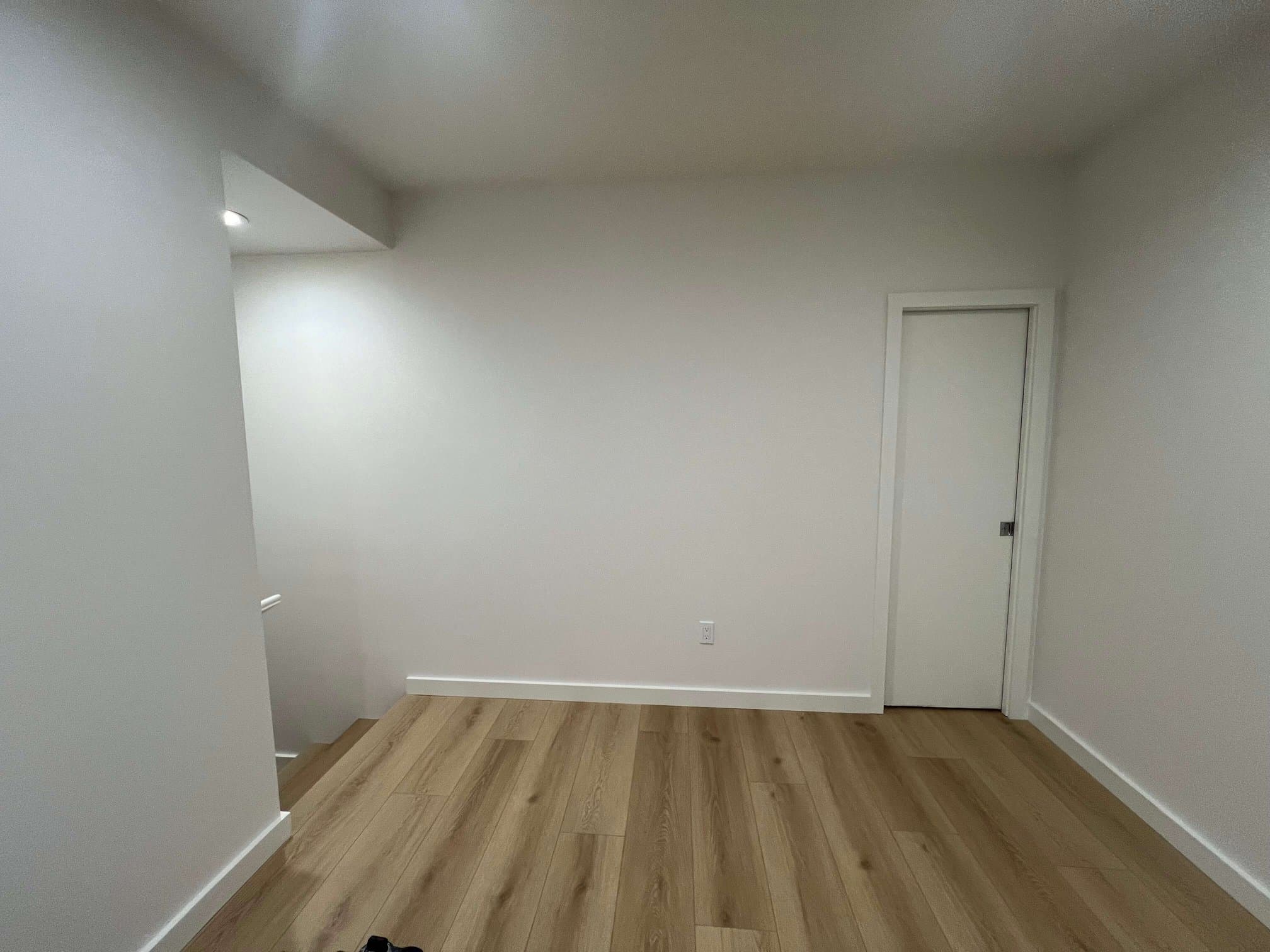 Finished light oak laminate flooring.