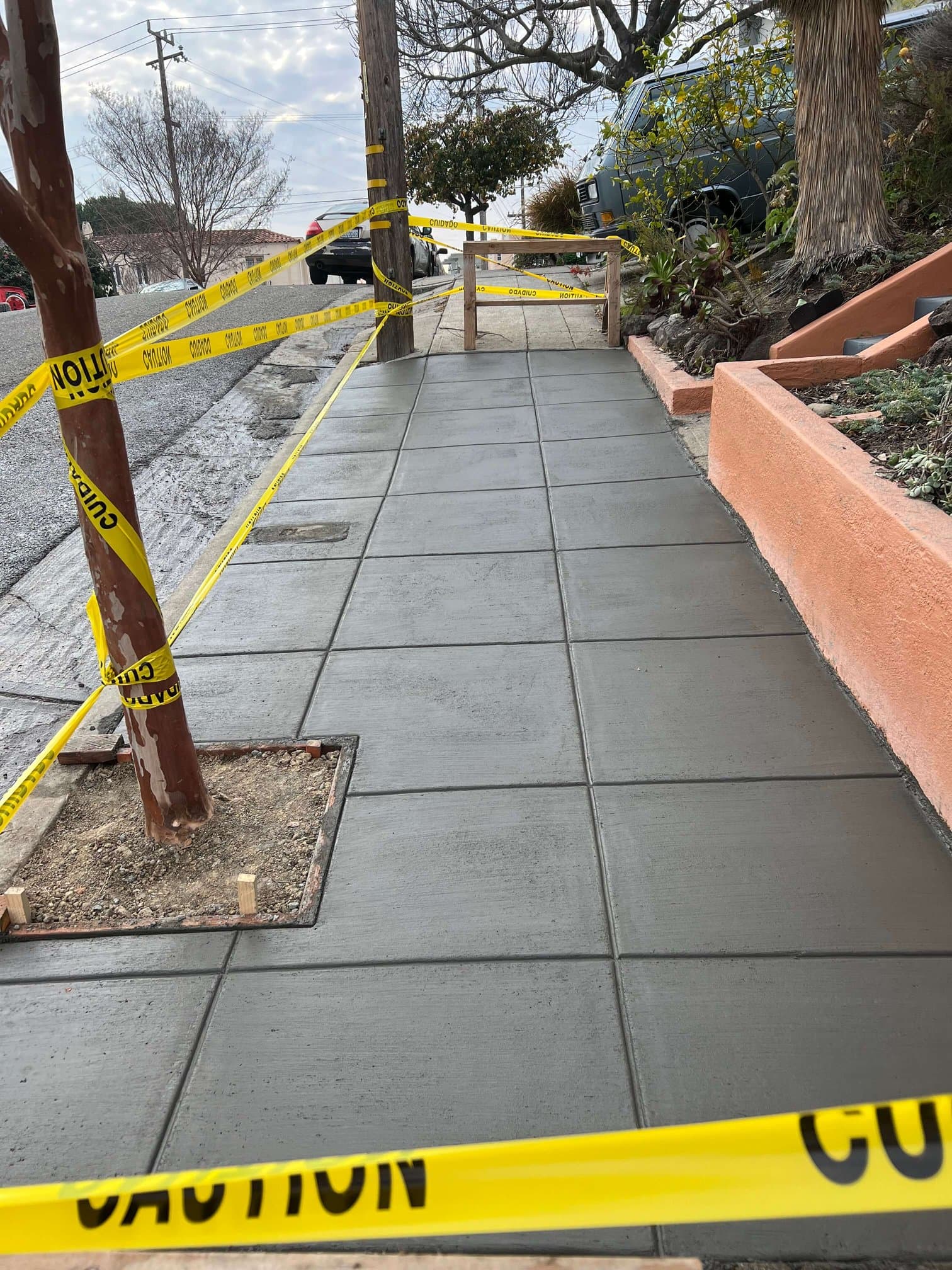 Fresh concrete sidewalk scored into panels