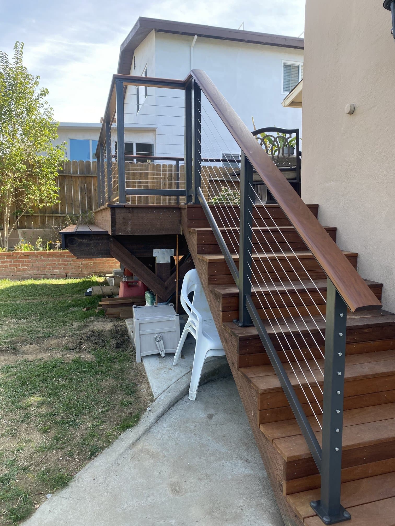 Outdoor wood stairs with matching cable railing down from the deck
